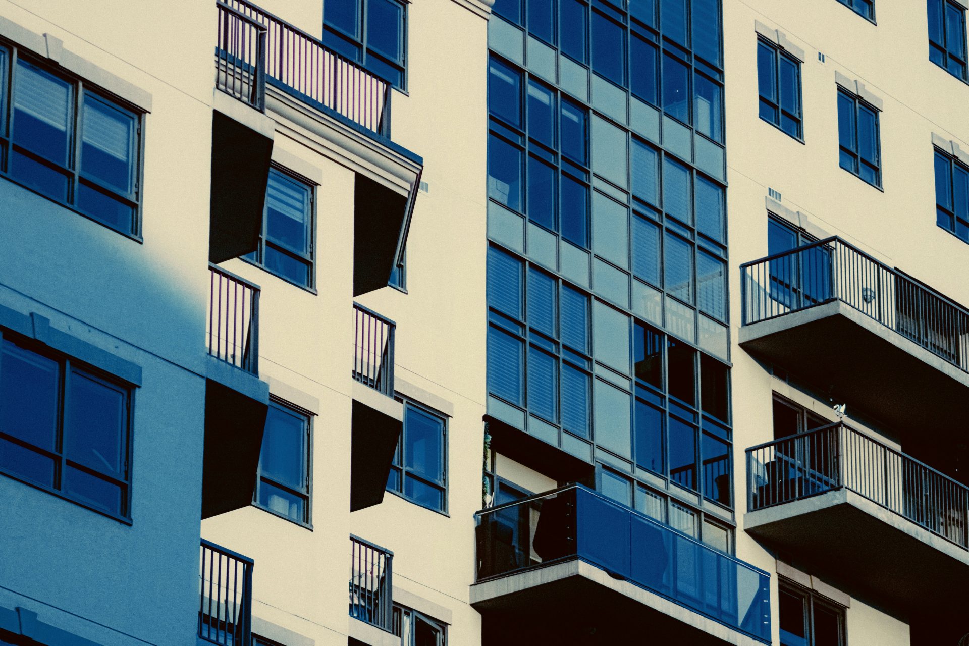 Modern apartment building with balconies and glass windows